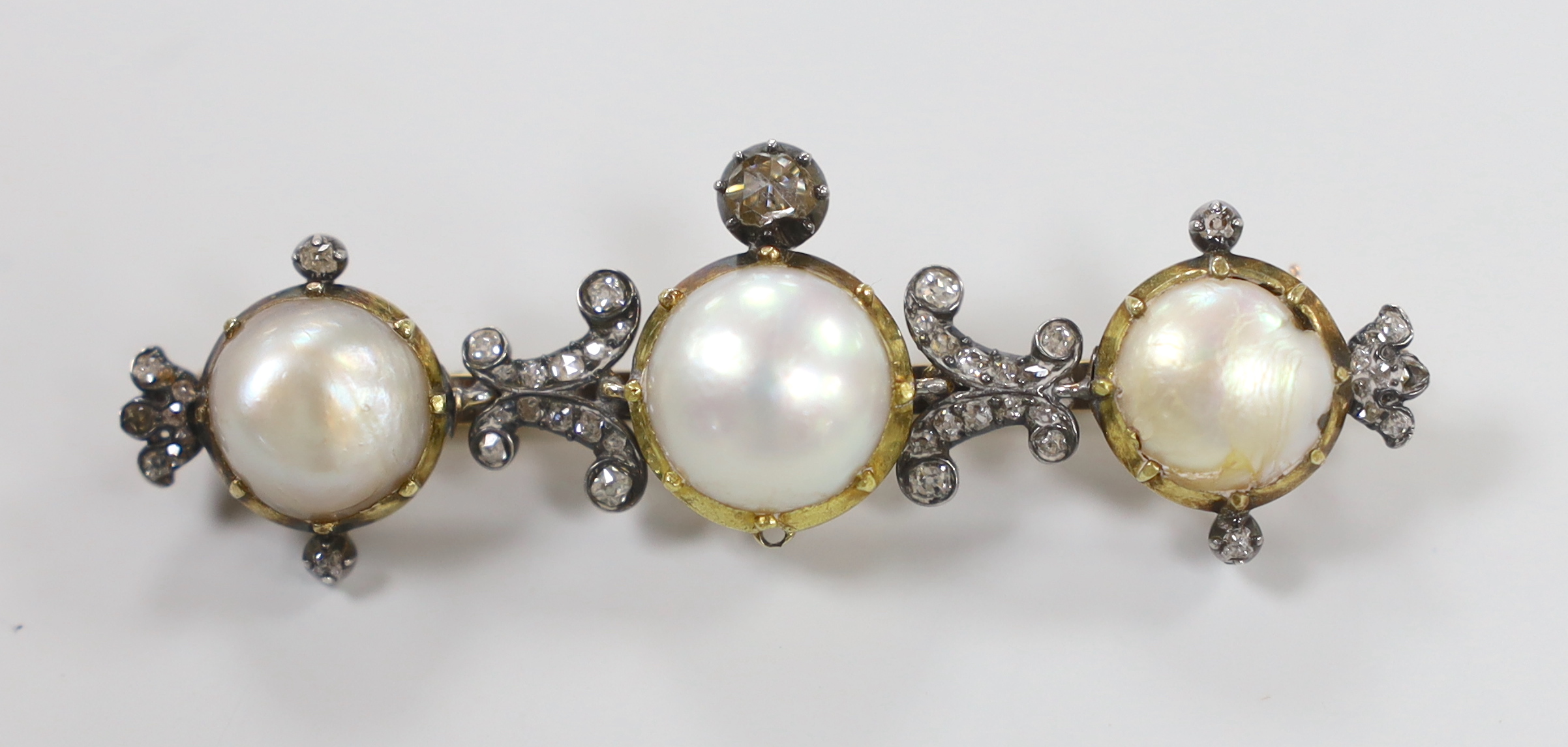 A late Victorian gold and silver, diamond and three stone half pearl set cluster bar brooch